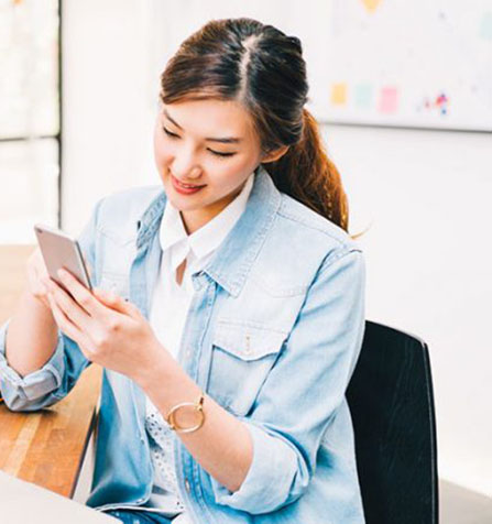 Young lady searching for her first job on her mobile phone